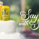 Can of Samuel Adams Summer Ale next to a tall amber glass filled with beer on top of a white wedding cake; on right, a graphic that says "Say it with Sam"